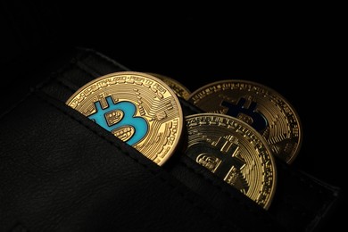 Photo of Cryptocurrency. Bitcoins in wallet on dark background, closeup