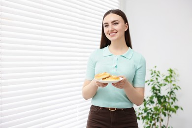 Photo of Gluten free diet. Young woman holding tasty pretzels indoors, space for text