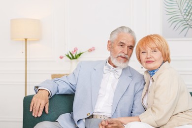 Photo of Lovely senior couple together on sofa at home