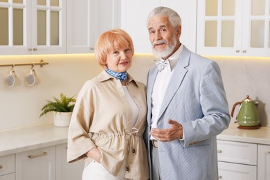 Photo of Lovely senior couple together in kitchen at home