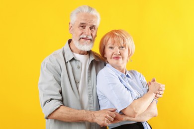 Photo of Lovely senior couple together on yellow background