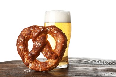 Photo of Tasty pretzel and glass of beer on wooden table against white background