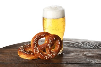 Photo of Tasty pretzels and glass of beer on wooden table against white background