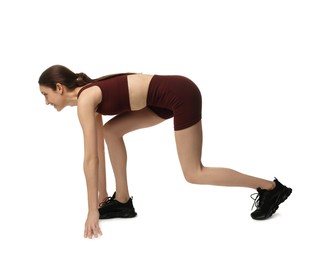 Photo of Runner in starting position on white background