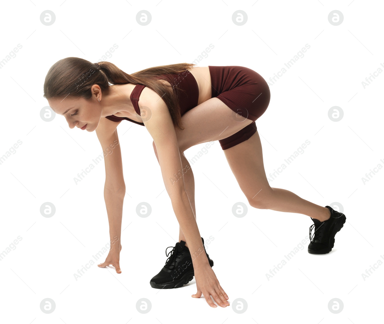 Runner in starting position on white background Photo of Runner in starting position on white background