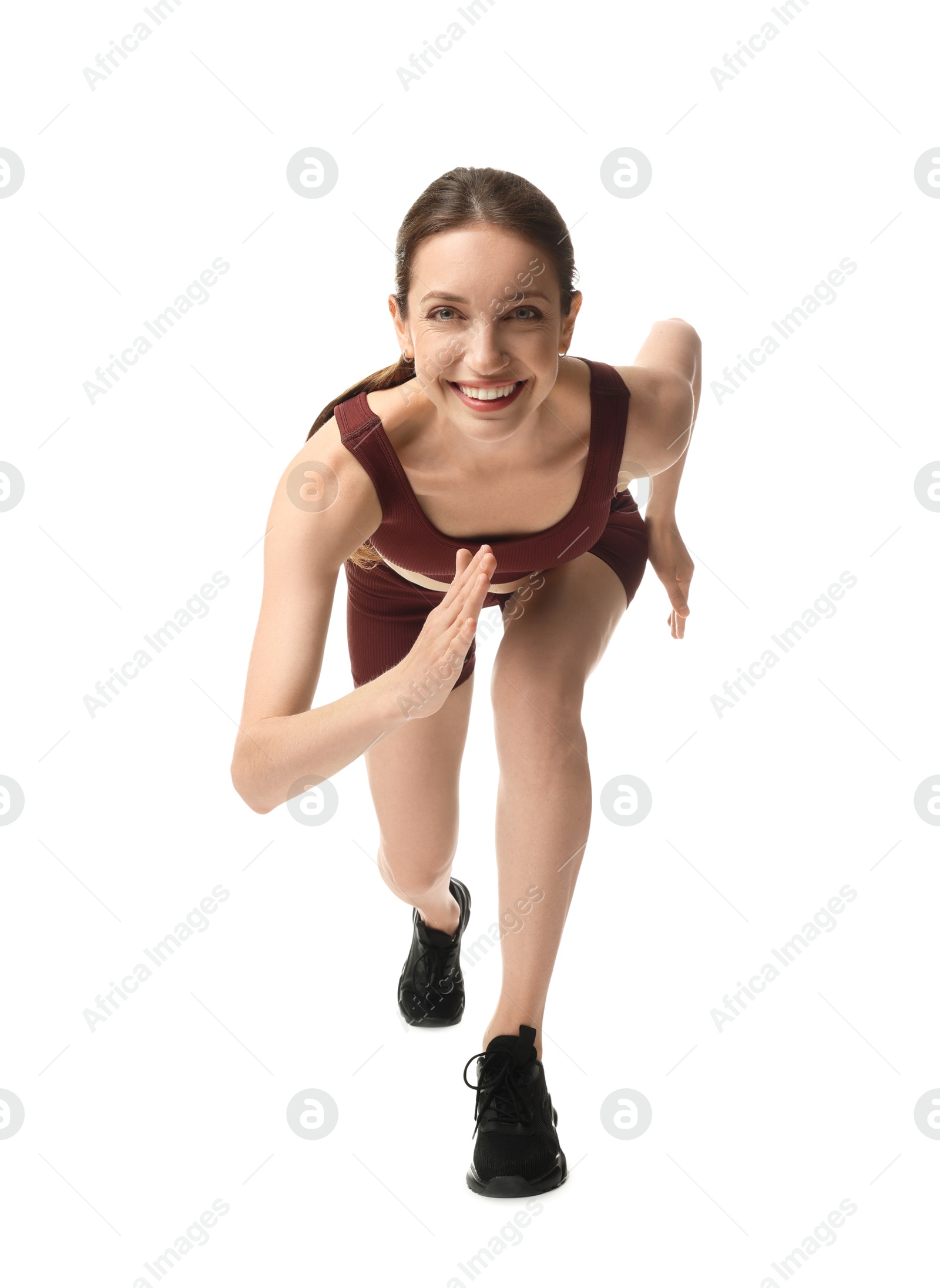 Woman in sportswear running on white background Photo of Woman in sportswear running on white background