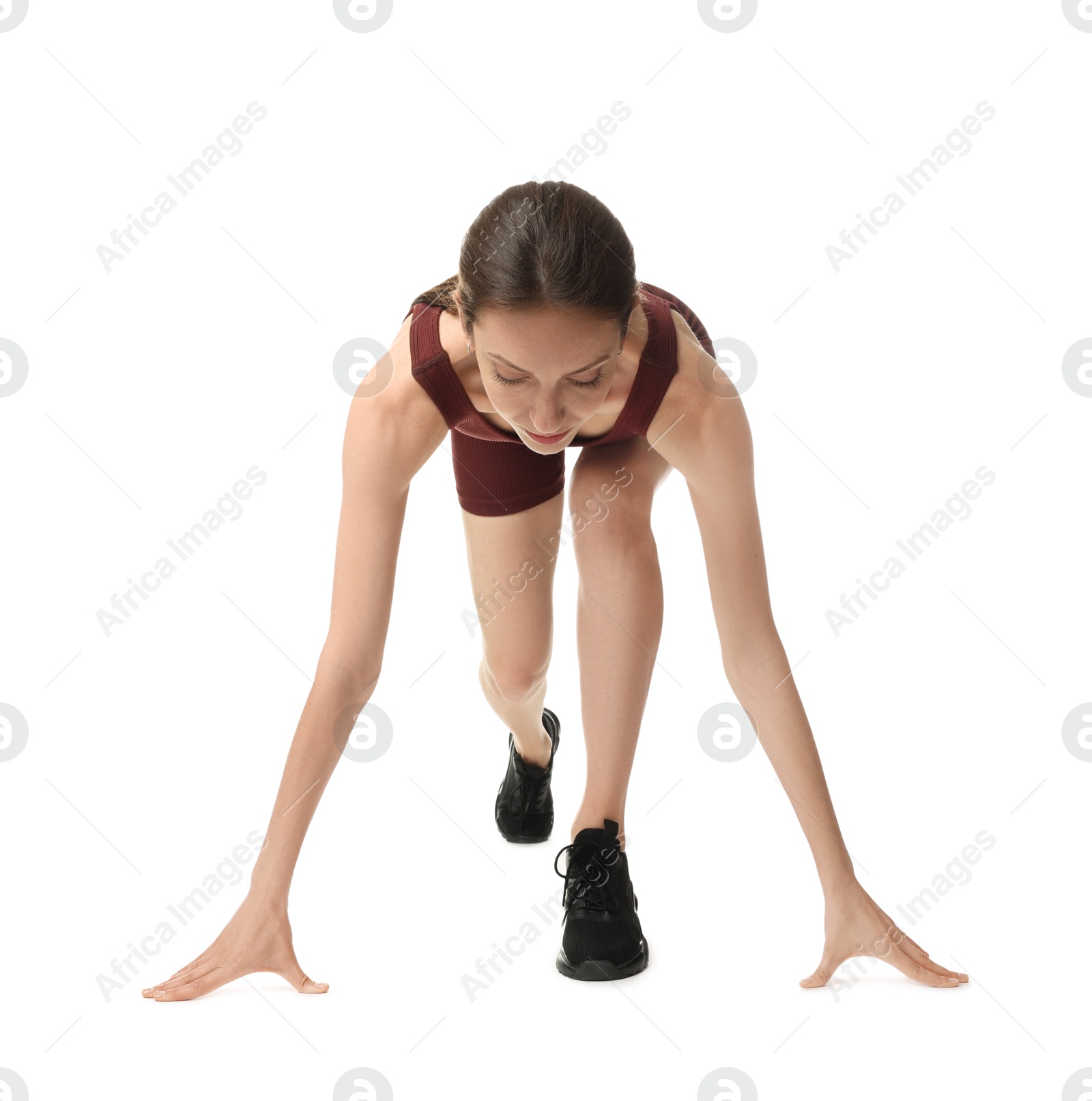 Runner in starting position on white background Photo of Runner in starting position on white background