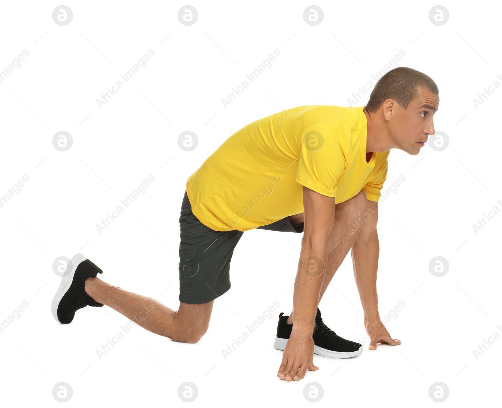 Runner in starting position on white background Photo of Runner in starting position on white background