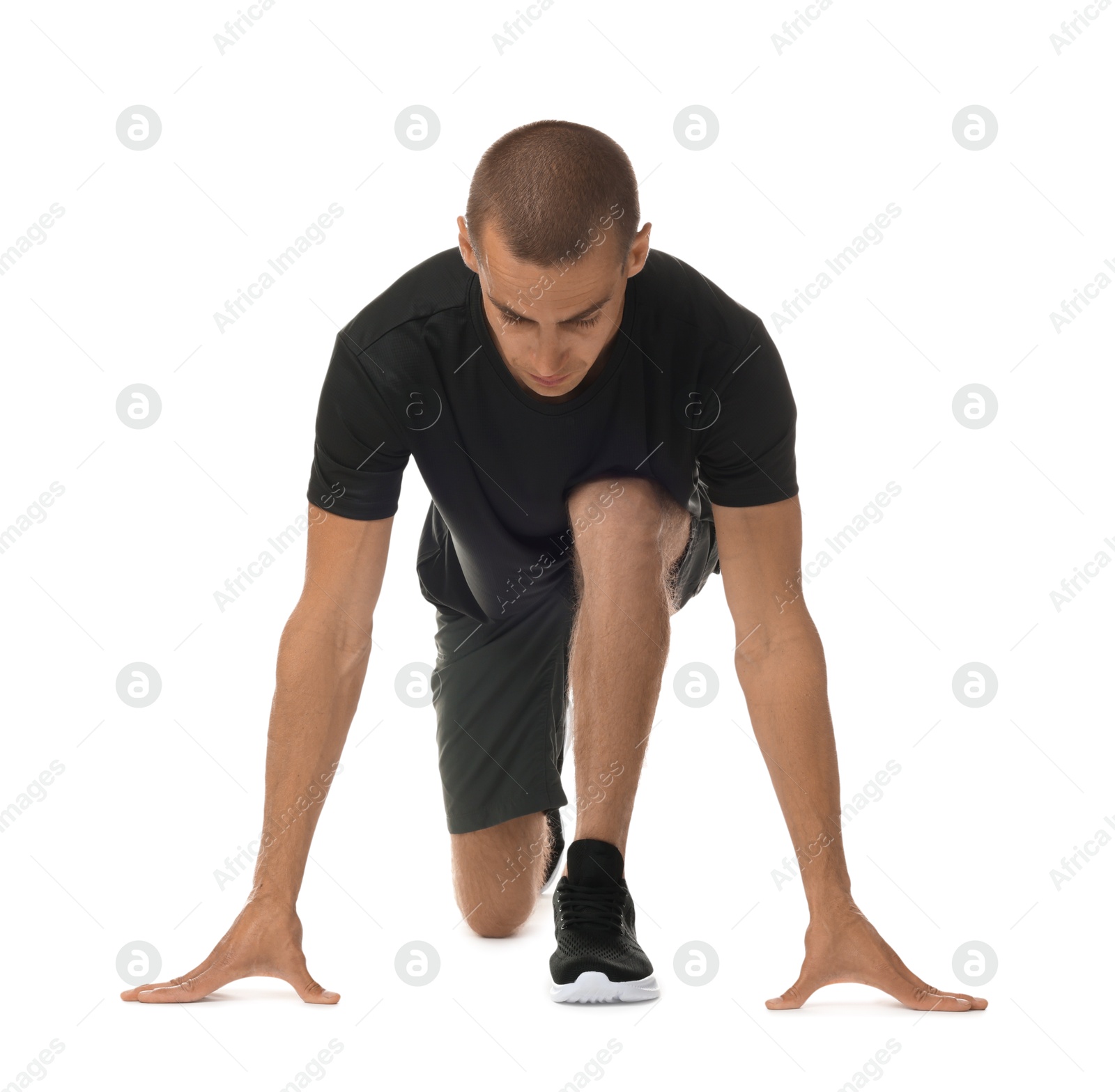 Runner in starting position on white background Photo of Runner in starting position on white background