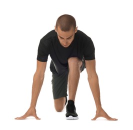 Photo of Runner in starting position on white background