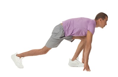 Photo of Runner in starting position on white background
