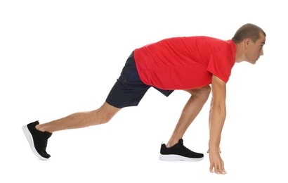 Photo of Runner in starting position on white background
