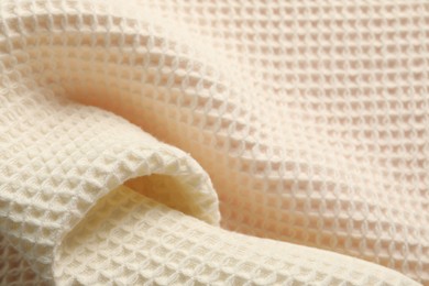 Photo of Clean beige waffle towel as background, closeup