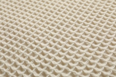 Photo of Clean beige waffle towel as background, closeup