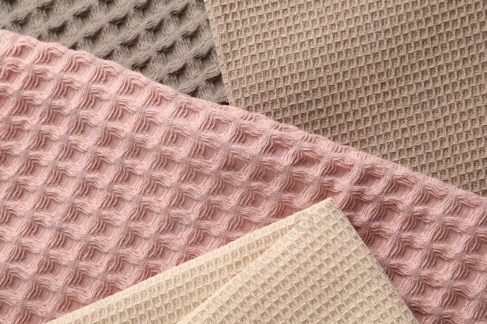 Different colorful waffle towels as background, top view Photo of Different colorful waffle towels as background, top view