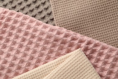 Photo of Different colorful waffle towels as background, top view