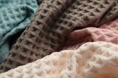 Photo of Different colorful waffle towels as background, closeup