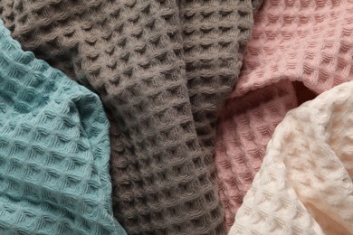 Photo of Different colorful waffle towels as background, top view