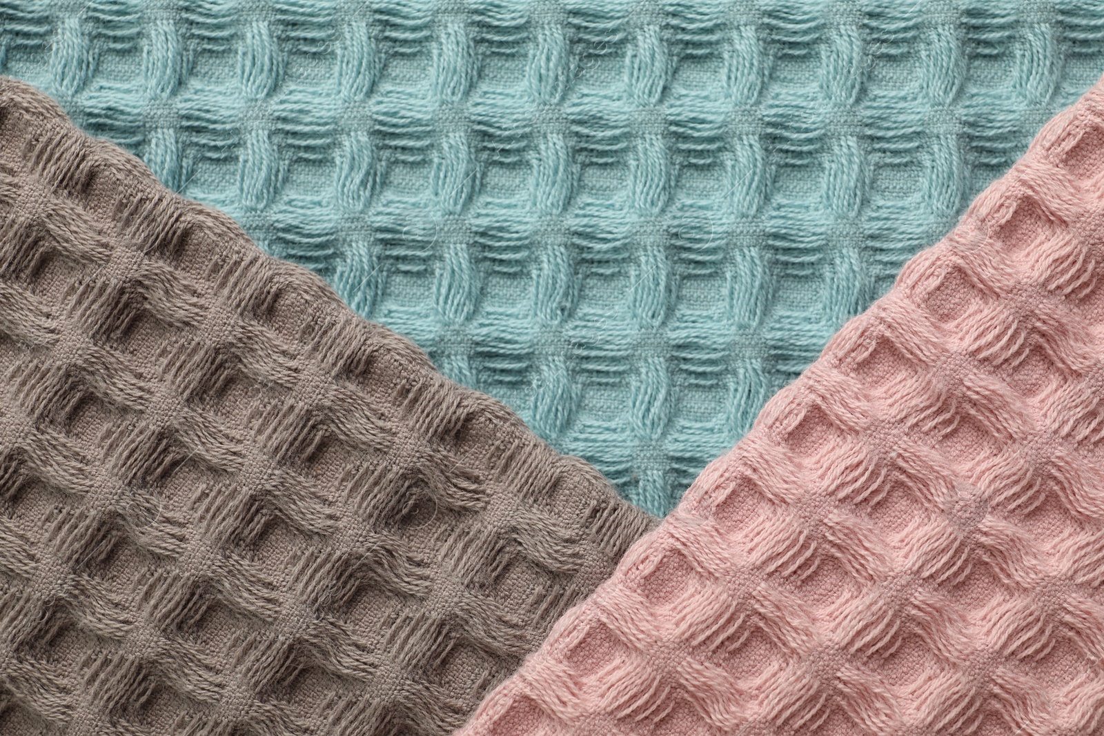 Different colorful waffle towels as background, top view Photo of Different colorful waffle towels as background, top view