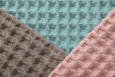 Photo of Different colorful waffle towels as background, top view
