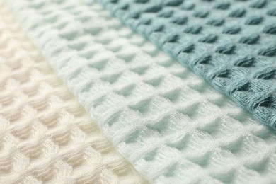 Photo of Different colorful waffle towels as background, closeup