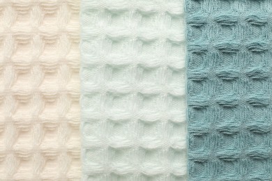 Photo of Different colorful waffle towels as background, top view