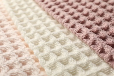 Photo of Different colorful waffle towels as background, closeup