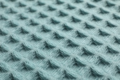 Photo of Clean light blue waffle towel as background, closeup