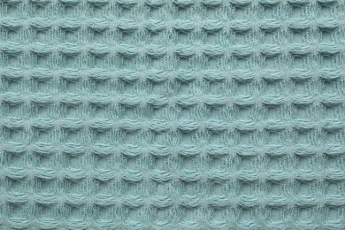 Photo of Clean light blue waffle towel as background, top view