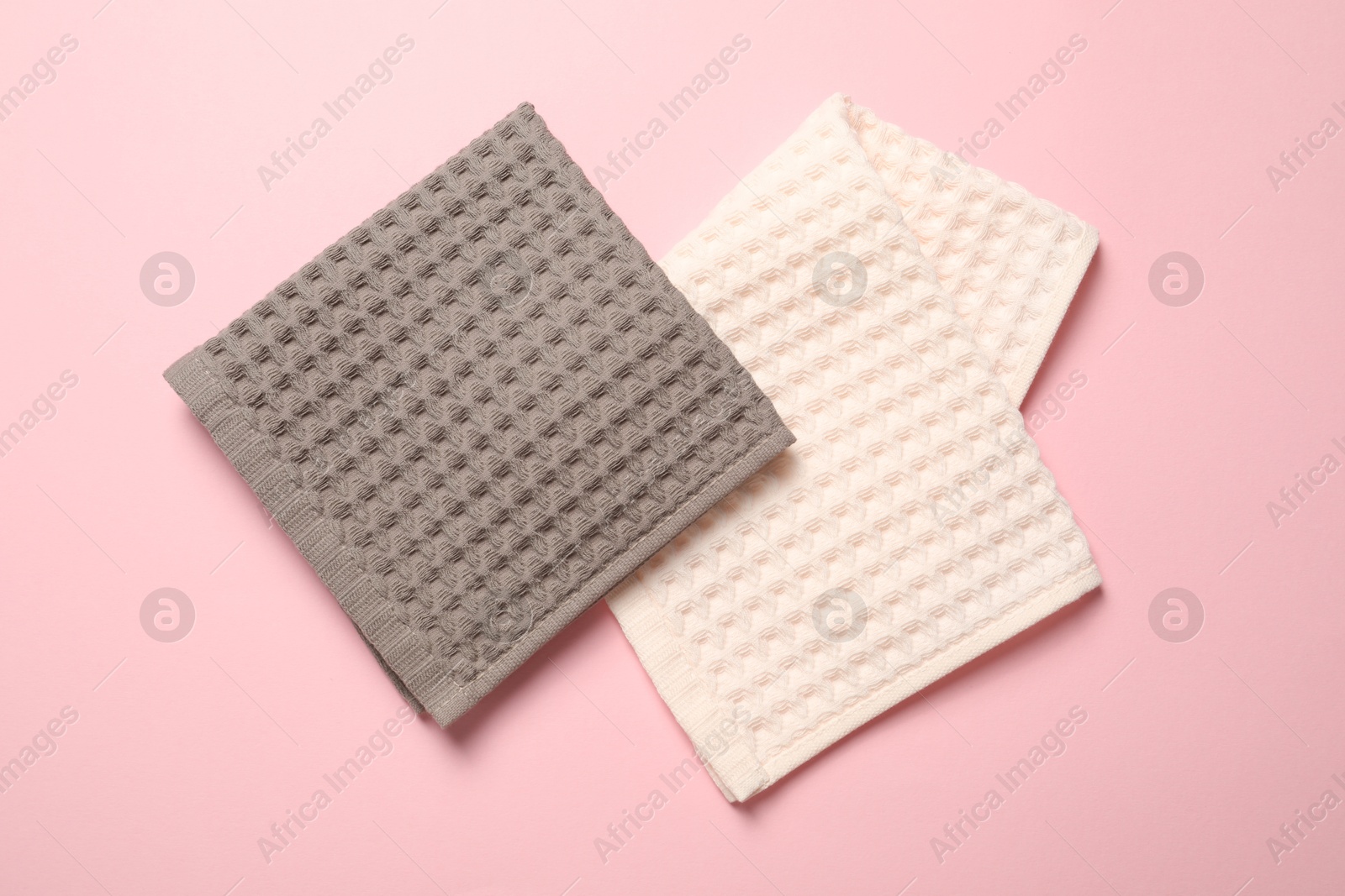 Clean waffle towels on pink background, flat lay Photo of Clean waffle towels on pink background, flat lay