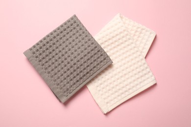 Photo of Clean waffle towels on pink background, flat lay