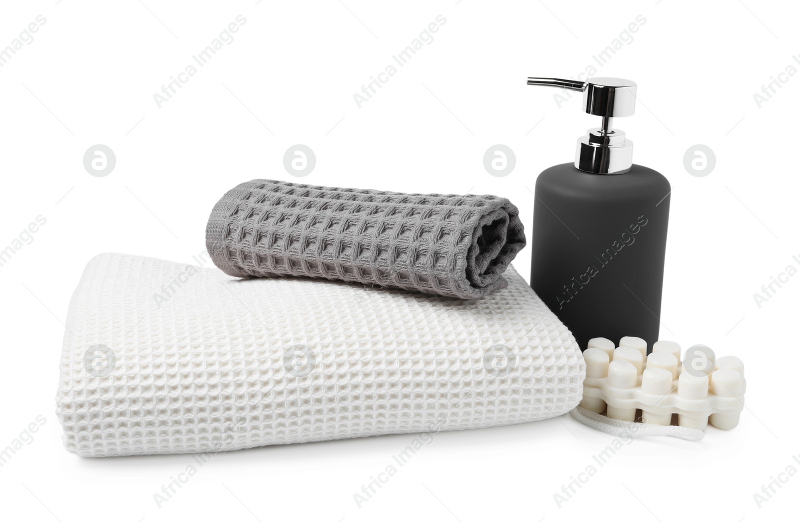 Clean waffle towels and soap isolated on white Photo of Clean waffle towels and soap isolated on white