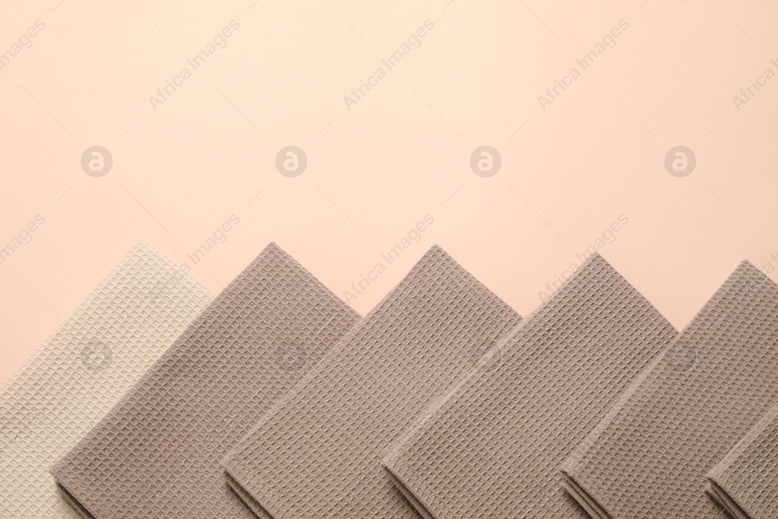 Clean waffle towels on beige background, flat lay. Space for text Photo of Clean waffle towels on beige background, flat lay. Space for text