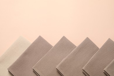 Photo of Clean waffle towels on beige background, flat lay. Space for text
