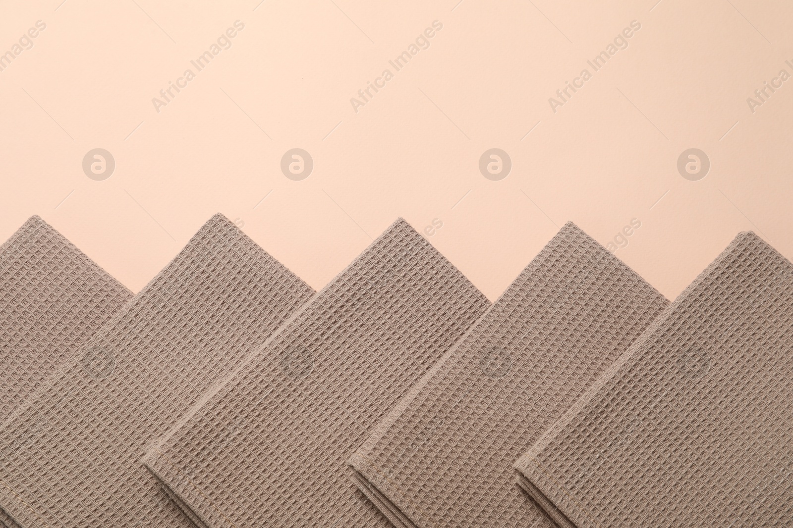 Clean waffle towels on beige background, flat lay. Space for text Photo of Clean waffle towels on beige background, flat lay. Space for text