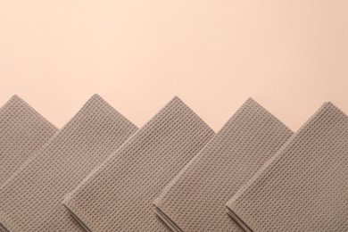Photo of Clean waffle towels on beige background, flat lay. Space for text