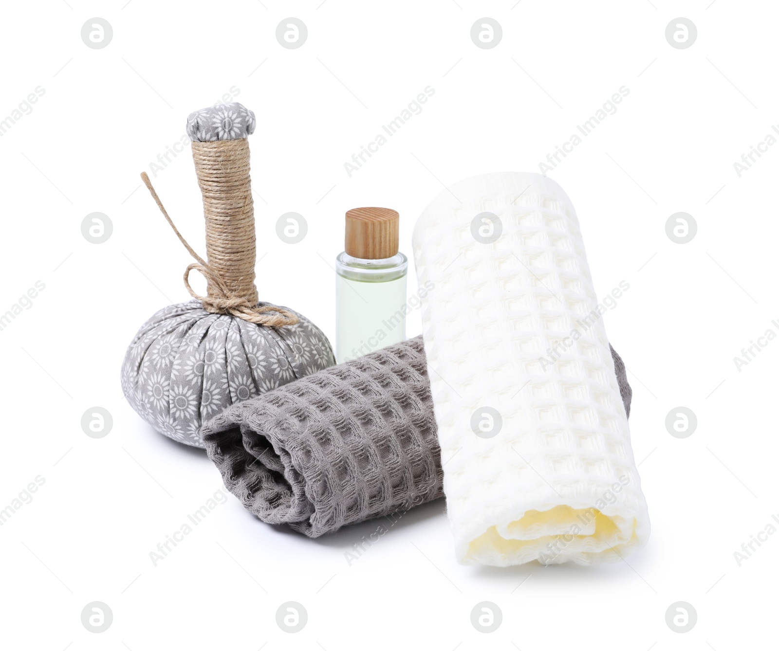 Clean waffle towels, massage bag and cosmetic product isolated on white Photo of Clean waffle towels, massage bag and cosmetic product isolated on white