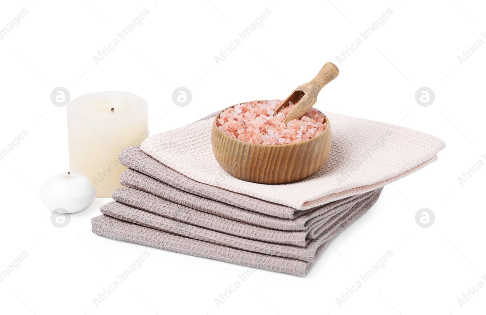 Photo of Clean waffle towels, candles and sea salt isolated on white