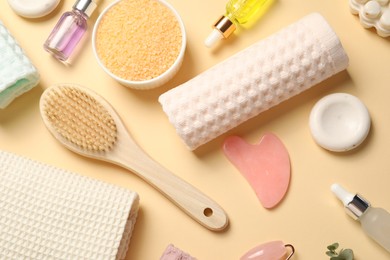 Photo of Clean waffle towels, cosmetic products and supplies on beige background, flat lay