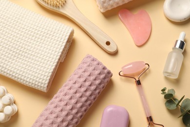 Photo of Clean waffle towels, cosmetic products and supplies on beige background, flat lay