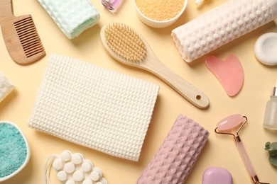 Photo of Clean waffle towels, cosmetic products and supplies on beige background, flat lay