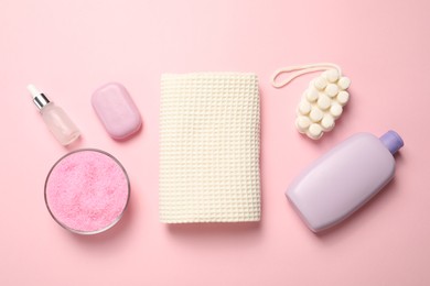 Photo of Clean waffle towel and cosmetic products on pink background, flat lay