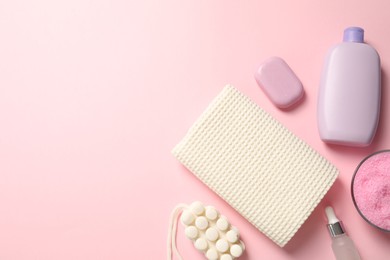 Photo of Clean waffle towel and cosmetic products on pink background, flat lay. Space for text