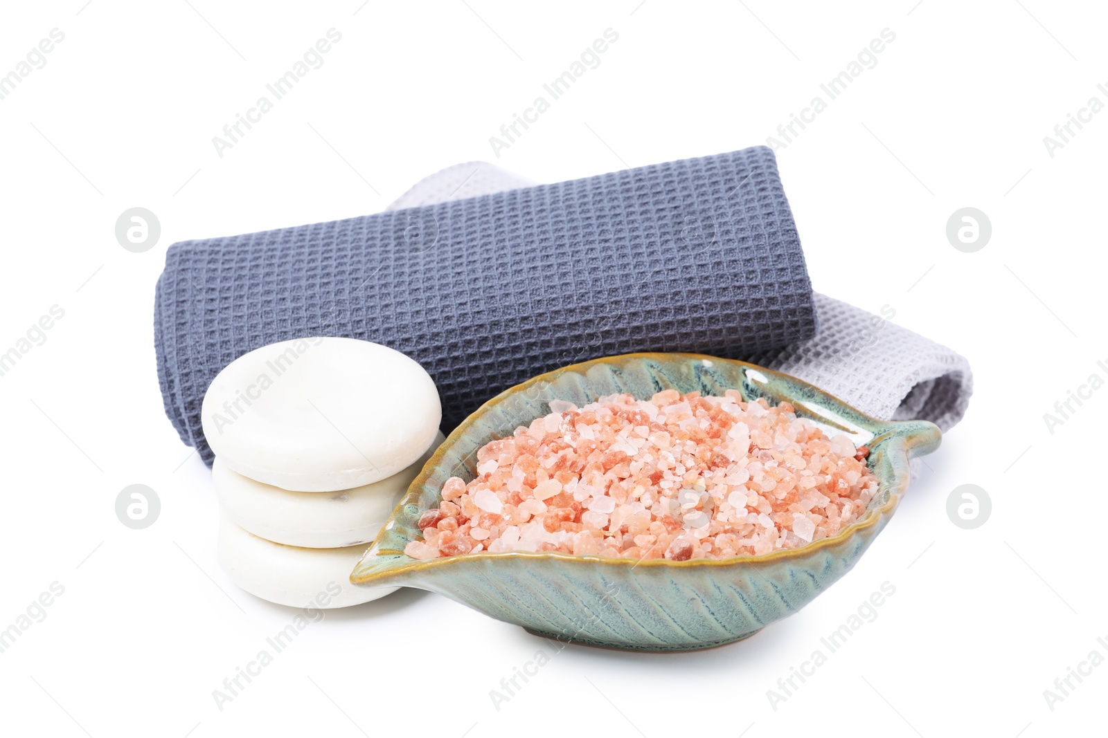 Clean waffle towels, sea salt and spa stones isolated on white Photo of Clean waffle towels, sea salt and spa stones isolated on white