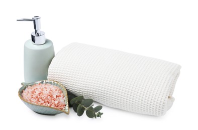 Photo of Clean waffle towel, sea salt, soap and eucalyptus branch isolated on white