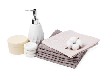 Photo of Clean waffle towels, cosmetic products, spa stones and cotton flower isolated on white