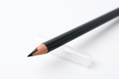 Photo of Black eyebrow pencil on white background, closeup