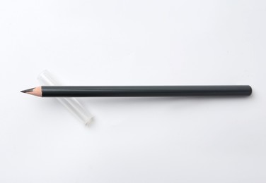 Photo of Black eyebrow pencil on white background, top view
