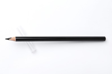 Photo of Black eyebrow pencil on white background, top view
