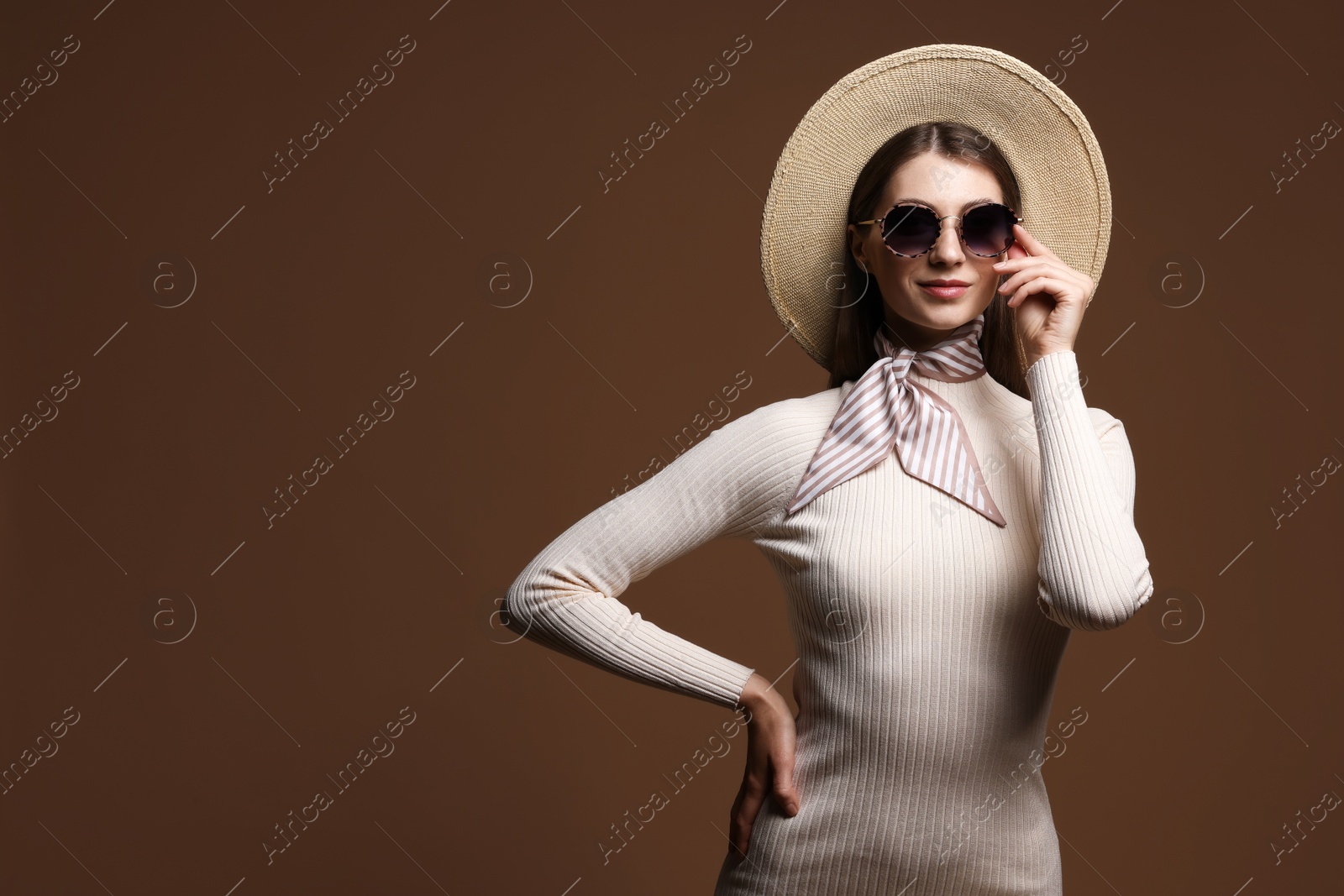 Fashionable portrait of beautiful woman in stylish outfit on brown background. Space for text Photo of Fashionable portrait of beautiful woman in stylish outfit on brown background. Space for text